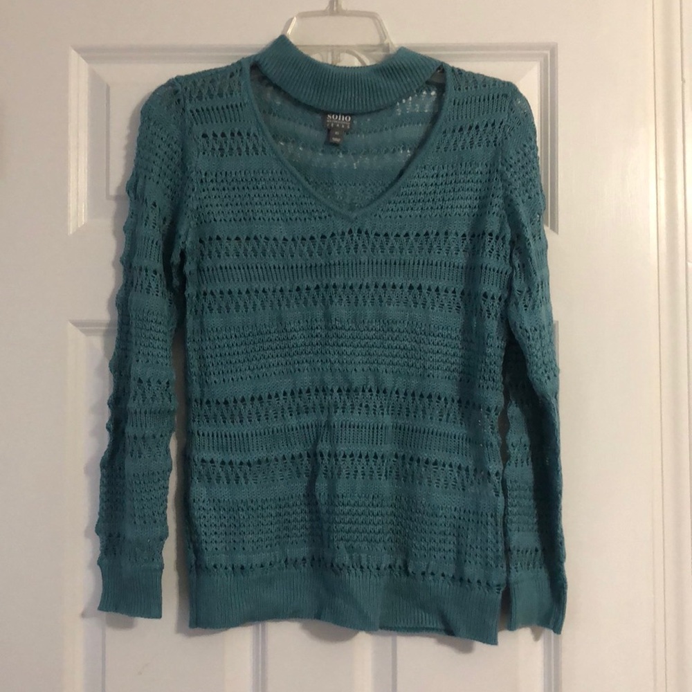 Blue V-neck sweater with neck strap .